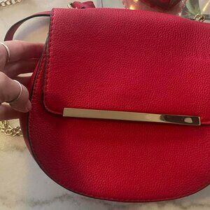 Red crossbody bag with gold hardware
